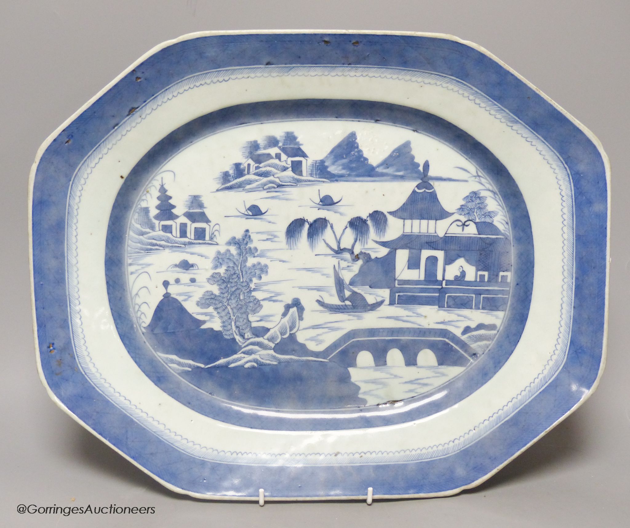 A 19th century Chinese export blue and white plate, decorated with pagoda scenes, length 42cm